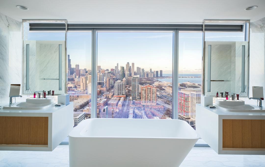 A part of J&H Signature Construction group's hospitality portfolio, the presidential bathroom suite includes a freestanding tub with windows overlooking downtown Chicago